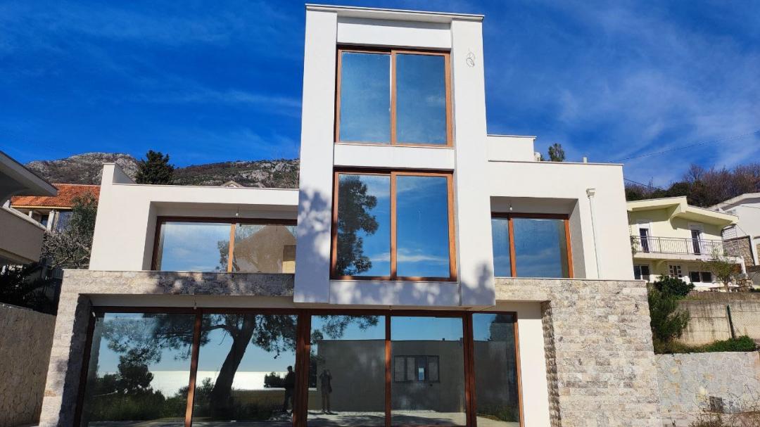 <p>A status object for connoisseurs of privacy, architectural expressiveness, and engineering thoughtfulness.<br>The villa is located 400 meters from the sea, on a quiet street among pine trees. The house was built according to an approved architectural project with a valid building permit.<br>________________________________________<br>Architectural parameters<br>• Total house area: 292 m² + spacious first-level terrace<br>• Plot: 400 m²<br>• Additionally: 100 m² of common area (guest parking)<br>• Detached garage: 40 m² (with building permit)<br>• Private parking area in front of the house<br>The object forms an expressive three-level volume with a well-thought-out logic of private and public spaces.<br>________________________________________<br>Layout structure<br>1st floor:<br>living room with access to the pool, dining room, kitchen, bathroom, staircase, large terrace.<br>2nd floor:<br>3 bedrooms, bathroom, 2 spacious balconies.<br>3rd floor:<br>1 master bedroom, bathroom, 2 large balconies.<br>The layout is oriented towards scenic views and natural insolation.<br>________________________________________<br>Engineering solutions<br>The object is prepared for a high standard of operation:<br>• central heating system (underfloor heating)<br>• possibility of connecting a heating boiler or solar panels<br>• connections for a heat pump<br>• wiring for radiators in bedrooms<br>• preparation for central air conditioning<br>• connection to the city water supply and sewerage system<br>• additional water tank with a volume of more than 18 m³<br>________________________________________<br>Swimming pool<br>In front of the house there is a 7 × 3.5 m swimming pool with an overflow system.<br>The construction is complete; installation of circulation, cleaning and lighting systems is provided.<br>________________________________________<br>Current stage of readiness<br>The following works are planned:<br>• installation of sanitary equipment<br>• installation of railings and fences<br>• installation of climatic equipment and heating elements<br>• installation of boilers<br>• landscaping, fencing and outdoor lighting<br>• final completion of the pool<br>The object is offered at a high stage of construction readiness, which allows the future owner to implement an individual interior concept.<br>This villa is a rational choice for a client who values legal purity, engineering preparation and a strategically correct location in the green coastal zone of Bar.</p>